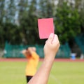 Hand of referee with red card