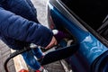 Hand refilling the car with fuel at the refuel station Royalty Free Stock Photo