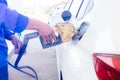 Hand refilling the car with fuel at the refuel station Royalty Free Stock Photo