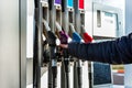 Hand refilling the car with fuel at the refuel station Royalty Free Stock Photo