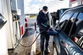 Hand refilling the car with fuel at the refuel station Royalty Free Stock Photo