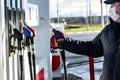 Hand refilling the car with fuel at the refuel station Royalty Free Stock Photo