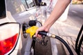 Hand refilling the car with fuel at the refuel station Royalty Free Stock Photo
