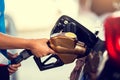 Hand refilling the white pickup truck with fuel at the gas station