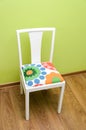 hand refurbished upholstered chair facing the wall