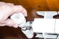 Hand regulates temperature in radiator Royalty Free Stock Photo