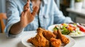 A hand rejecting fried chicken.AI generated image Royalty Free Stock Photo