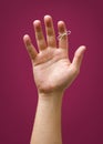 Hand with remider string isolated on red purple plum background Royalty Free Stock Photo