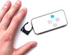 Hand and remote control for air humidifier control on white isolated background.