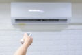 Hand remote control Turning the air conditioner Royalty Free Stock Photo