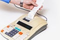 Hand removes check from printing calculator on white background Royalty Free Stock Photo