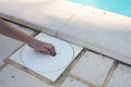 Hand removing the lid from a pool skimmer Royalty Free Stock Photo