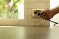 Hand removing plug from an over heated socket Royalty Free Stock Photo