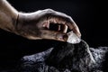 hand removing rare stone from a mine chinese diamond digging