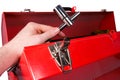 Hand removing a wrench from a toolbox