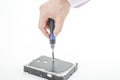 Hand repairman unscrews the 3.5 inch hard drive cover with a screwdriver. Royalty Free Stock Photo