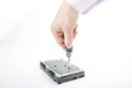 Hand repairman unscrews the 3.5 inch hard drive cover with a screwdriver. Royalty Free Stock Photo