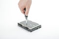 Hand repairman unscrews the 3.5 inch hard drive cover with a screwdriver. Royalty Free Stock Photo