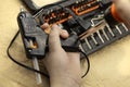 Hand repairs glue gun using tool