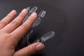 Hand resembling a handprint drawn by chalk on blackboard