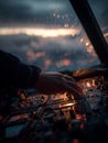 Hand rests on throttle as cockpit lights illuminate reflections of distant clouds during twilight flight Royalty Free Stock Photo