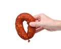 Hand with a ring of tasty smoked sausage on a white background Royalty Free Stock Photo