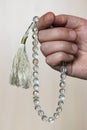 Hand with rock-crystal muslim beads tasbih