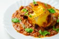 Hand rolled four cheese ravioli pasta in minced beef with Chianti red wine, garlic and herb ragu, and a bechamel sauce topped with Royalty Free Stock Photo