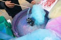 Hand rolling cotton candy in candy floss machine. Candyfloss making