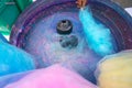 Hand rolling cotton candy in candy floss machine. Candyfloss making