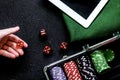 Hand is rolling the dice. Poker set in a metallic case, green ga