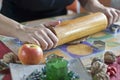Hand rolling out dough with rolling pin Royalty Free Stock Photo