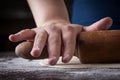 Hand on a rolling pin preparing pizza dough Royalty Free Stock Photo