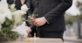 Hand, rose and a person at a funeral in a graveyard in grief while mourning loss at a memorial service. Death, flower Royalty Free Stock Photo