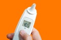 Electronic Electronic Thermometer with 38.1 Degree High Body Temperature COVID-19 Orange Background