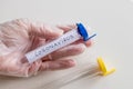 Hand in a rubber glove holding a laboratory vial with coronovirus, concept, epidemiological threat