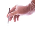 Hand in rubber glove holding tweezers Royalty Free Stock Photo