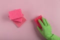 Hand in rubber glove holding washing sponge Royalty Free Stock Photo