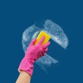 Hand in rubber glove washes the wall cleaner.