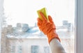 Hand in rubber glove washes a window. Royalty Free Stock Photo