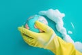 Hand in rubber gloves cleaning planet earth globe. Generative AI illustration Royalty Free Stock Photo