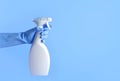 Hand with rubber gloves holding spray bottle Royalty Free Stock Photo