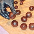 Hands making chocolate treats