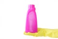 Hand in rubber yellow glove holds pink bottle of liquid bleach on white background. cleaning Royalty Free Stock Photo