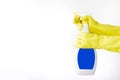 Hand in rubber yellow glove holds spray bottle of liquid detergent on white background. cleaning Royalty Free Stock Photo