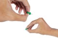 Hand's attaching a green thumbtack