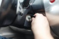 Hand s man plug in a key starting the engine of a car. Royalty Free Stock Photo