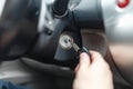Hand s man plug in a key starting the engine of a car. Royalty Free Stock Photo