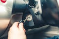 Hand s man plug in a key starting the engine of a car. Royalty Free Stock Photo