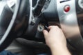 Hand s man plug in a key starting the engine of a car. Royalty Free Stock Photo